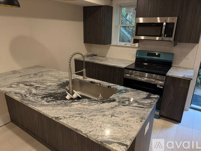 A kitchen with granite countertops and stainless steel appliances.
