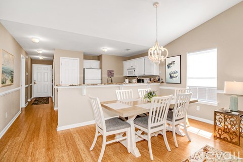 A dining room with a table set for four.