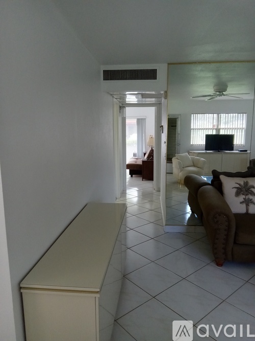 A living room with a television and a couch.