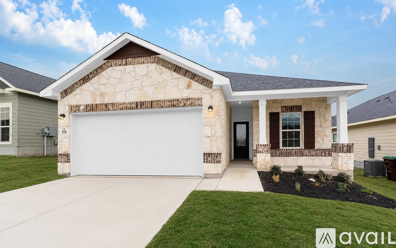 A house with a garage door and a driveway in front.