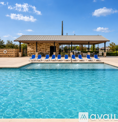 A pool with blue water and a pavilion with chairs.