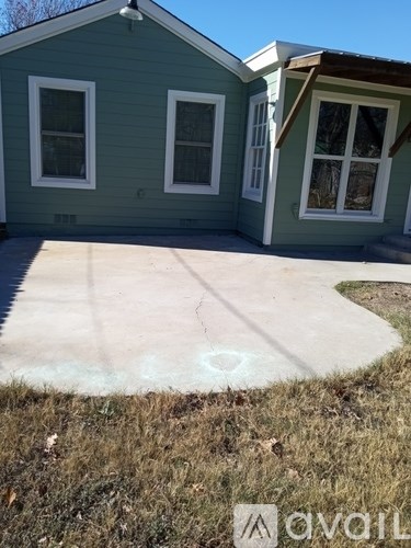 A house with a green siding and a white door.