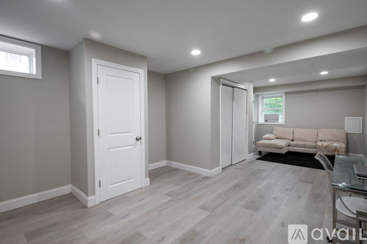 A living room with a white door and a couch.