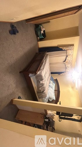 A small room with a bed and a light on.