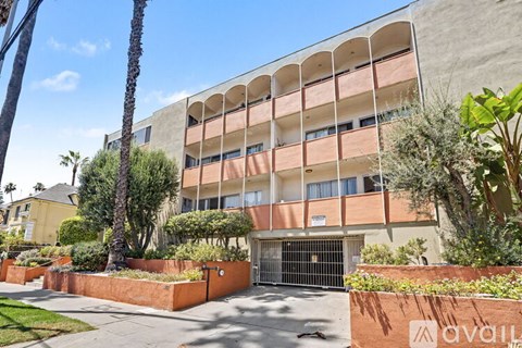 A building with a palm tree in front of it.