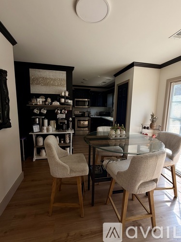 A dining room with a glass table and chairs.