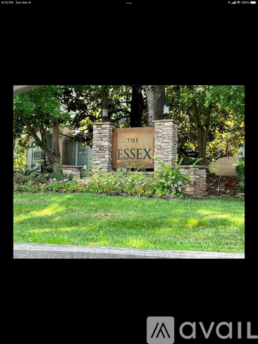 A sign that says "The Essex" is in front of a building.
