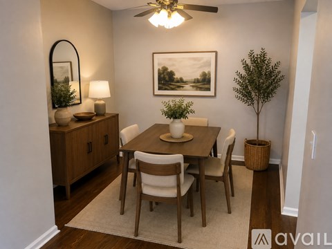 A dining room with a wooden table and chairs.
