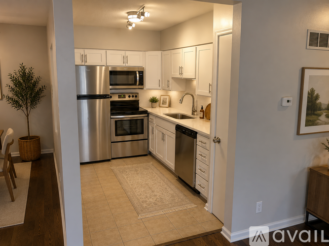 A kitchen with white cabinets and stainless steel appliances.
