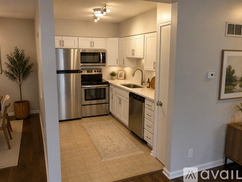 A kitchen with white cabinets and stainless steel appliances.