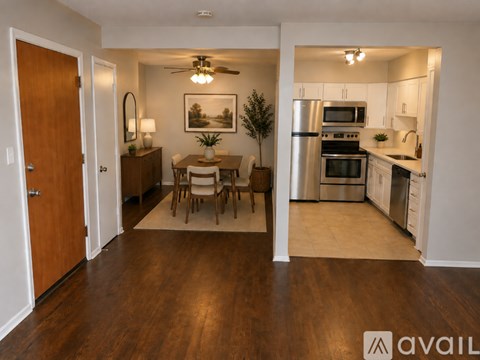 A kitchen with a dining table and chairs in the middle of the room.