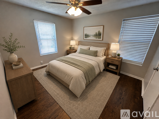 A bedroom with a bed, nightstand, and a ceiling fan.