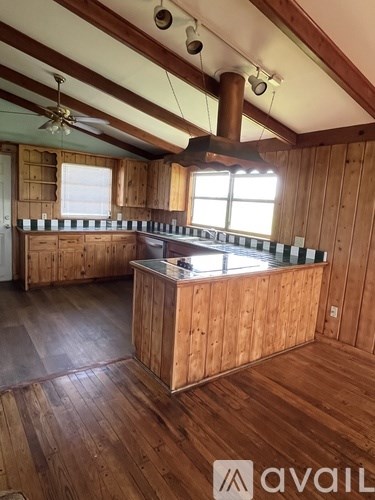 A kitchen with wooden cabinets and a central island.