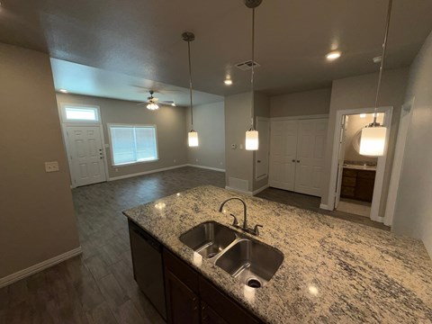 A kitchen with granite countertops and a sink.