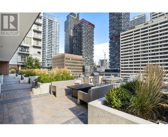 A rooftop patio with a view of the city skyline.