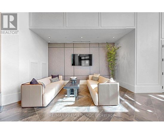 A living room with a white couch and a coffee table.