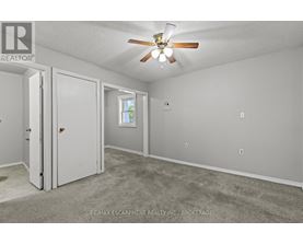 A room with a ceiling fan and a window.