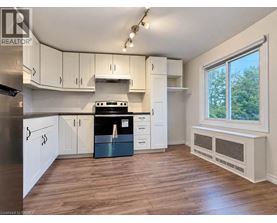 A kitchen with white cabinets and a black stove top oven.