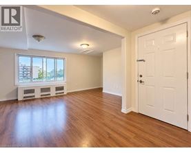 A room with wooden floors and a white door.