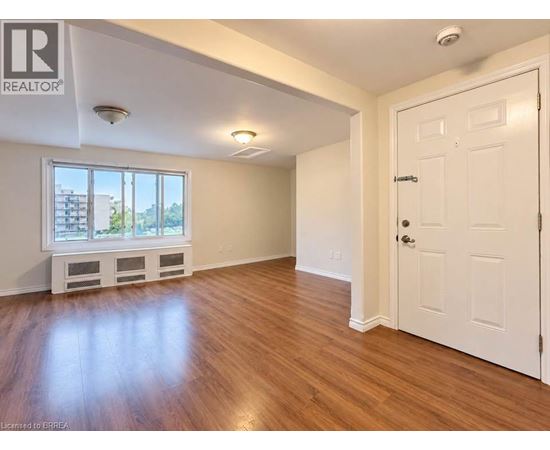 A room with wooden floors and a white door.