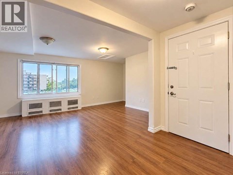 A room with wooden floors and a white door.