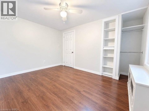 A room with a wooden floor and white walls.