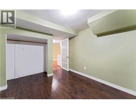 A room with wood flooring and a white closet.