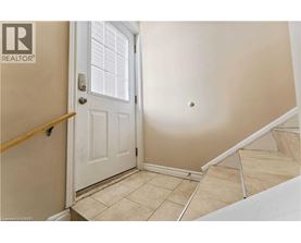 A white door is in a room with a tan wall.