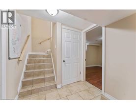 A hallway with a staircase leading to the second floor.