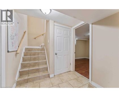 A hallway with a staircase leading to the second floor.