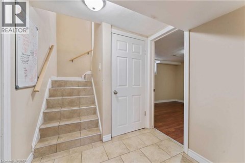 A hallway with a staircase leading to the second floor.