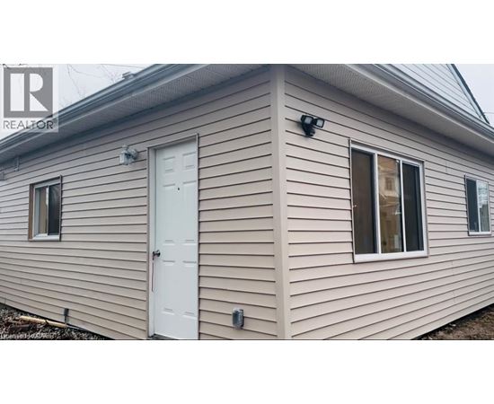 A house with a white door and windows is for sale.