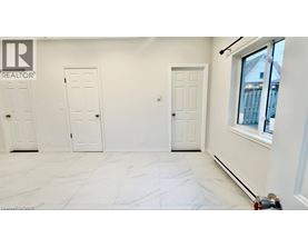 A white room with a marble floor and three doors.