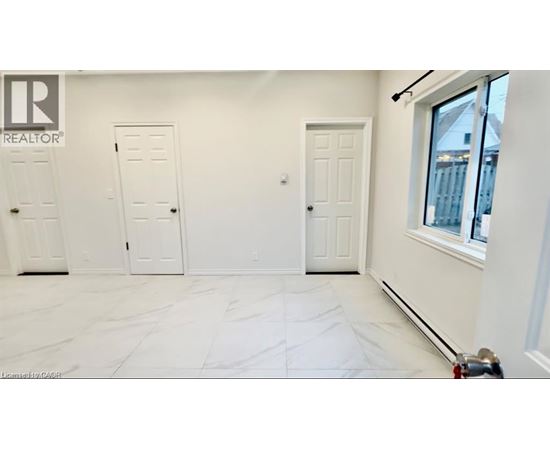 A white room with a marble floor and three doors.