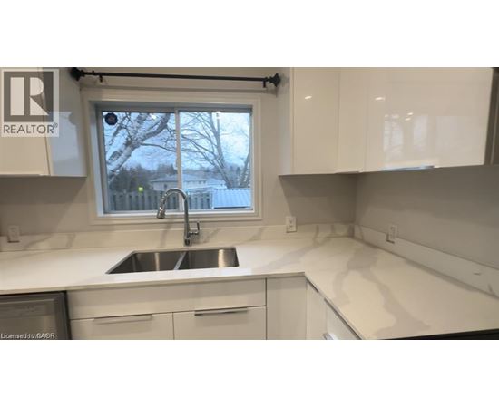 A kitchen with a sink and a window.