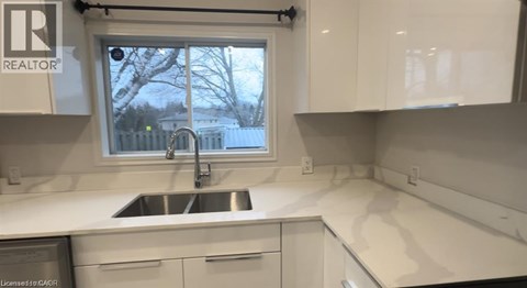 A kitchen with a sink and a window.
