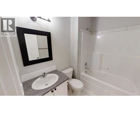 A bathroom with a sink, toilet, and bathtub.