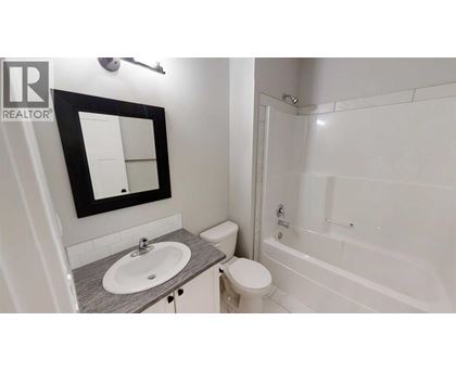 A bathroom with a sink, toilet, and bathtub.
