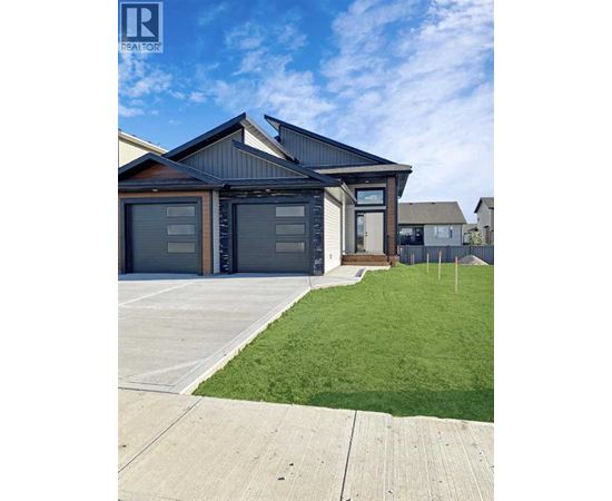 A modern house with a large garage is for sale.