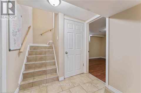 A hallway with a staircase leading to the second floor.