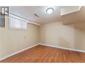 A room with wooden floors and a window with blinds.