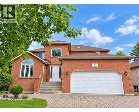 A red brick house with a white garage door and a number 512 on the front.