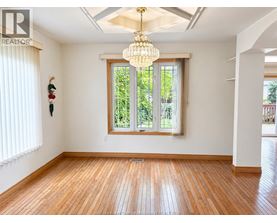 A room with wooden floors and a large window.