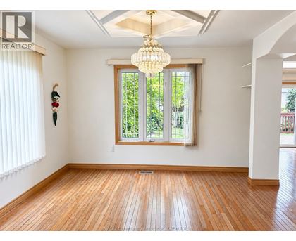 A room with wooden floors and a large window.
