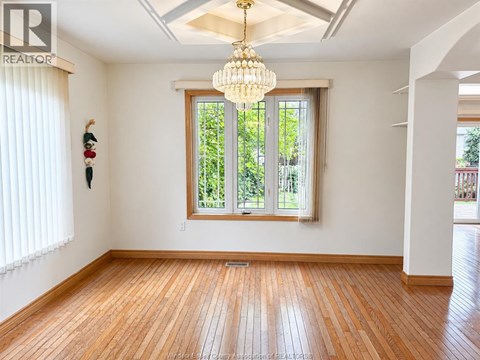 A room with wooden floors and a large window.
