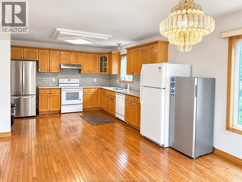 A kitchen with wooden cabinets and a white refrigerator.
