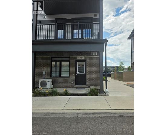 A building with a black door and windows with a sign that says REALTOR.