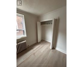 A room with a white wall and a white closet.