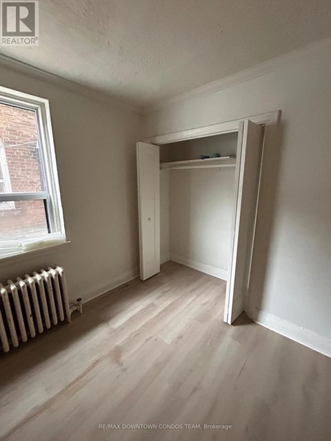 A room with a white wall and a white closet.