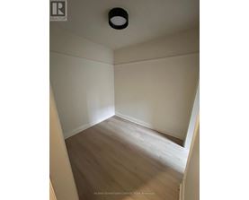 A room with a wooden floor and white walls.